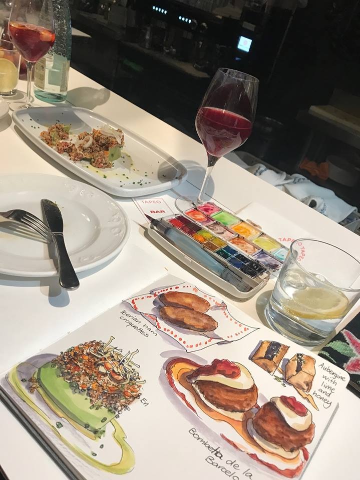 A sketch book with images of dinner served in a restaurant