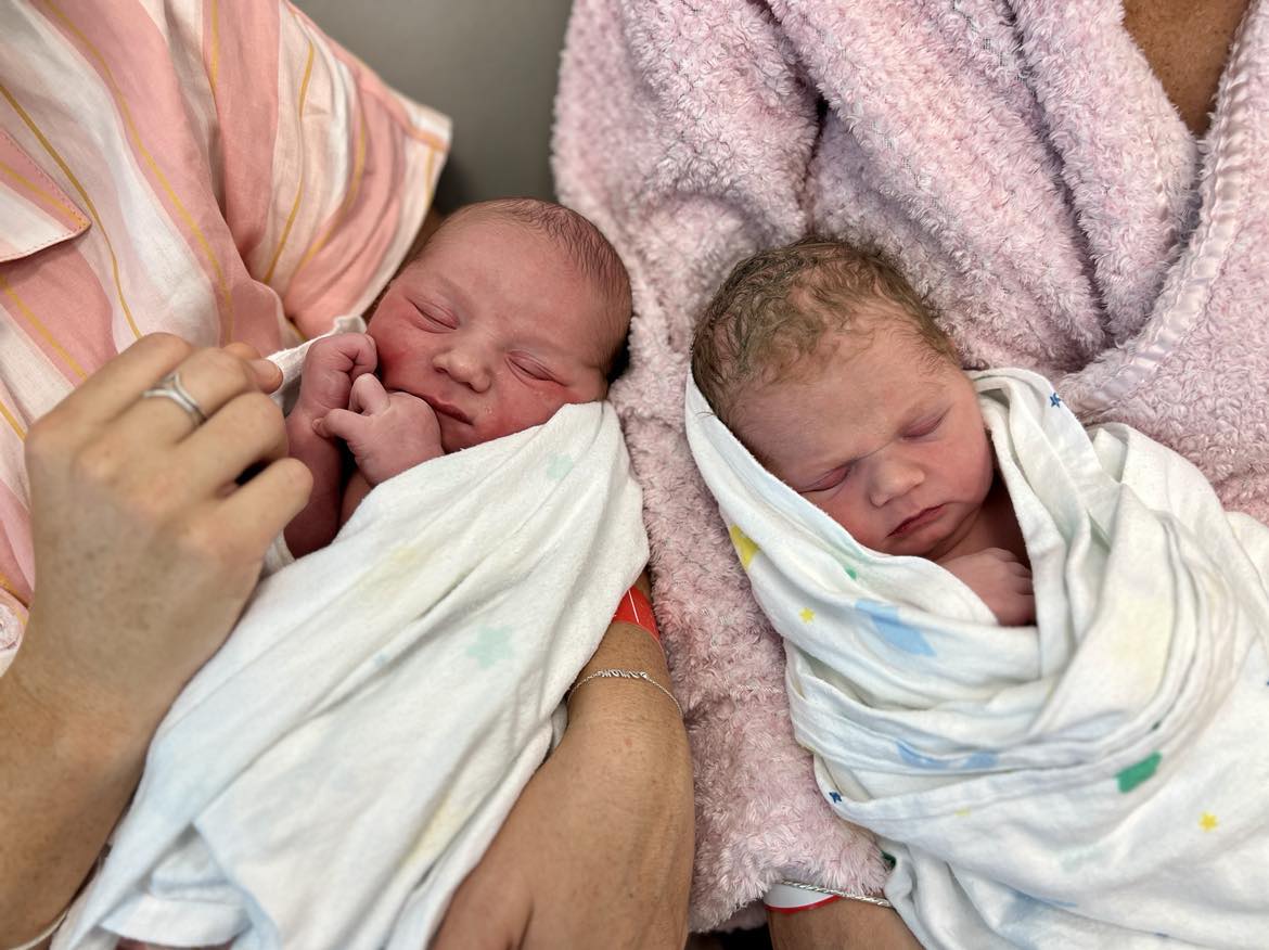 Two babies sleeping side by side