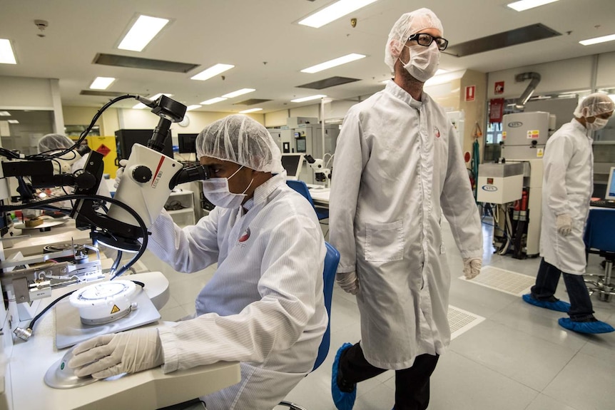 Scientists working around in the Australian National Fabrication Facility at UNSW, where quantum chips are created.