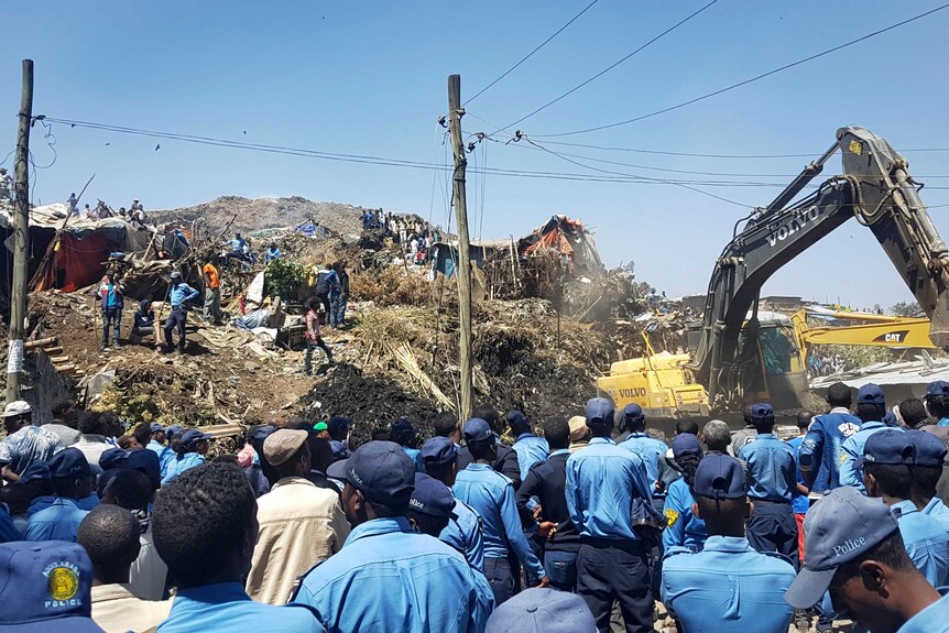 Police officers surround the scene of a garbage landline