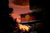 An aboriginal flag on a building at susnet