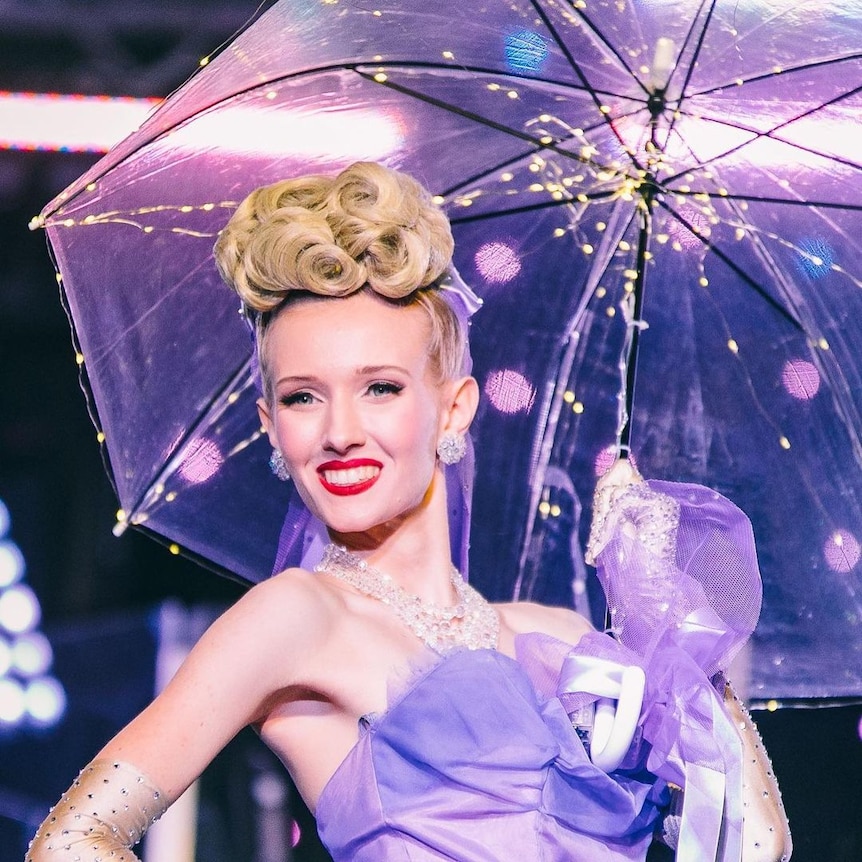 woman holding umbrella smiling