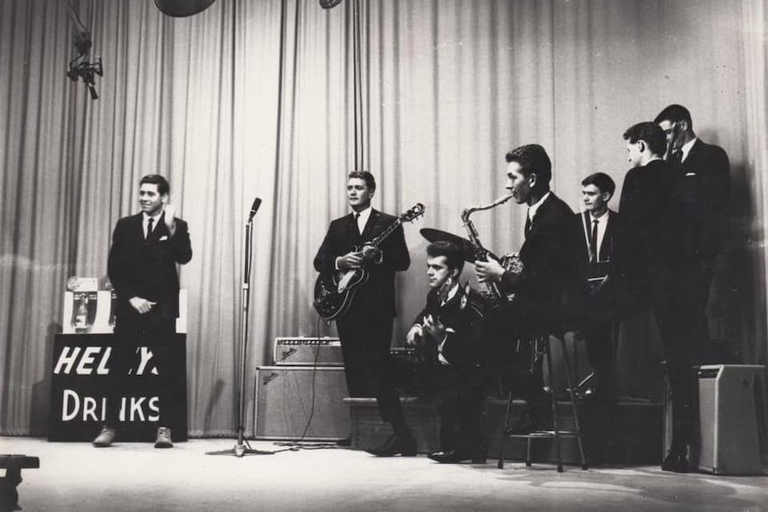 Black and white of Men playing in a band on stage in the 1960s