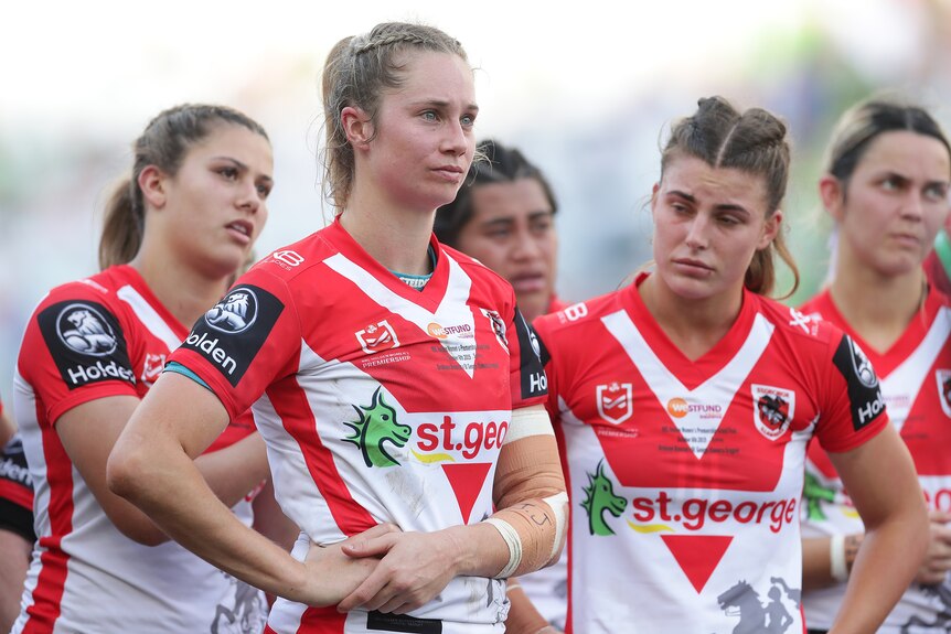A group of NRLW players close to tears after losing a grand final 