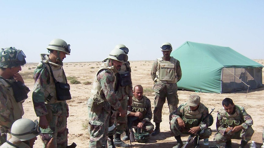 Iraqi troops meet during a training exercise