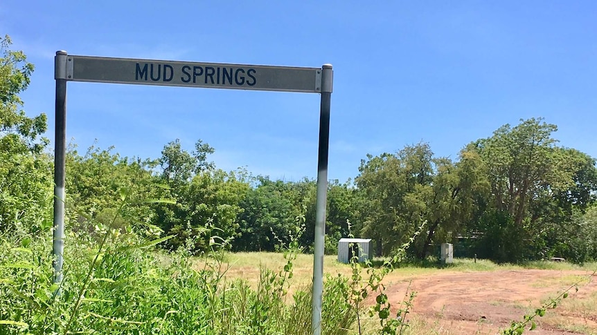 A close up of a sign which has Mud Springs written on it.