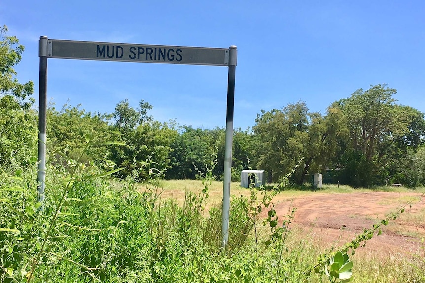 A close up of a sign which has Mud Springs written on it.