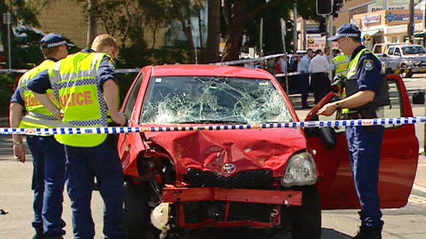 Police inspect the wreckage of the car after the accident at Kogarah.