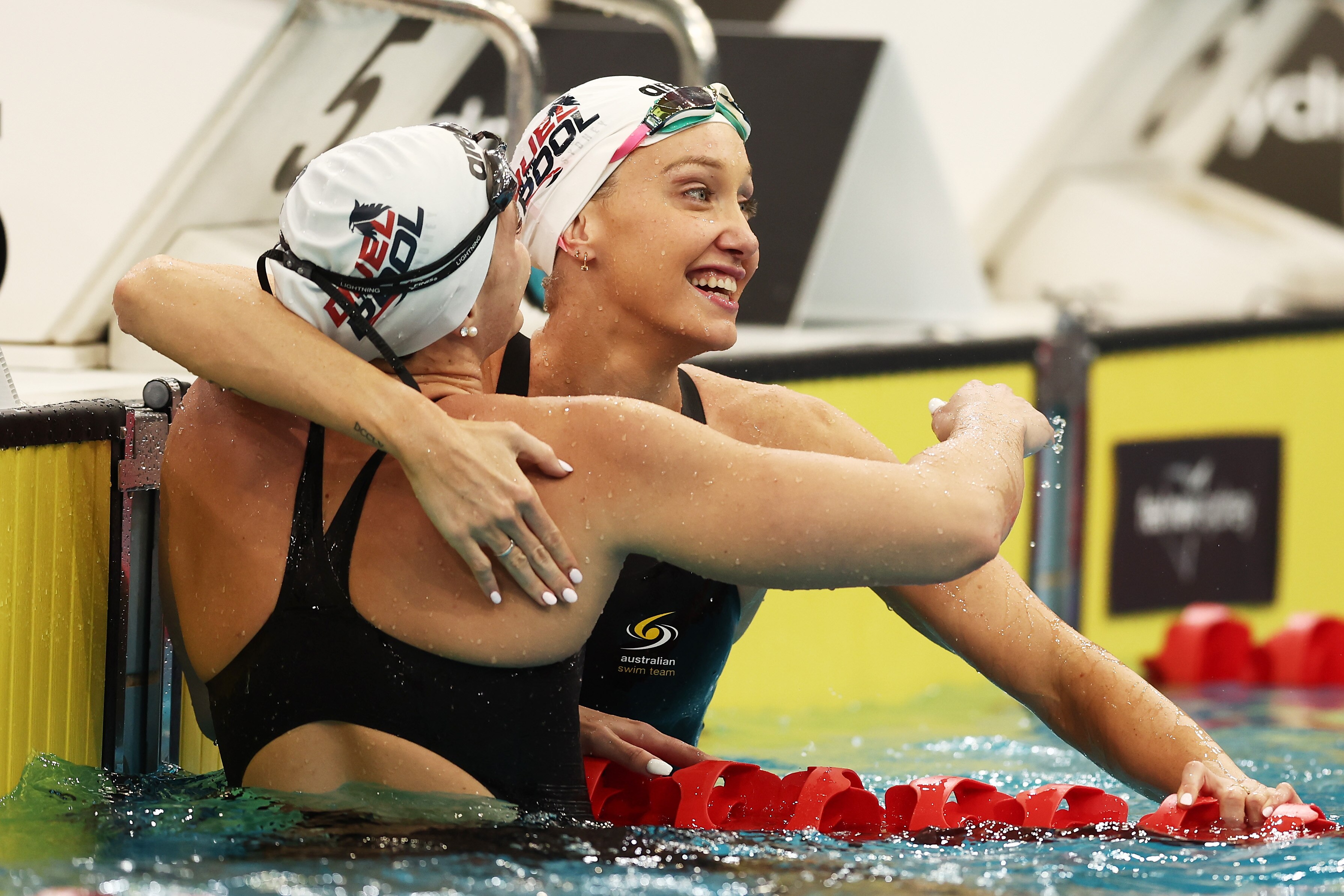 Shayna Jack and Madi Wilson hug in the pool