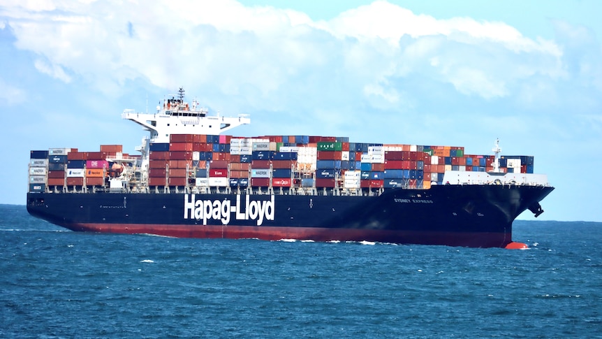 A container ship makes its way into Sydney's Port Botany with no land visible.