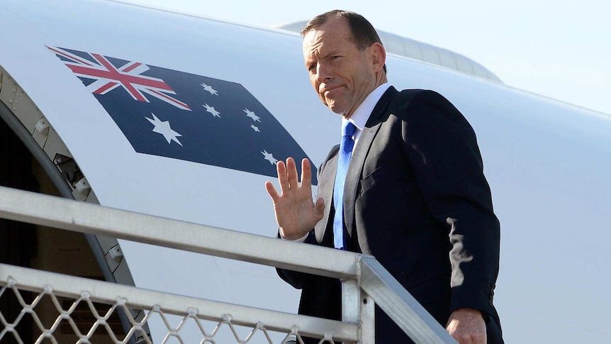 Prime Minister Tony Abbott boards an RAAF jet in Sydney.