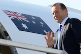 Prime Minister Tony Abbott boards an RAAF jet in Sydney.