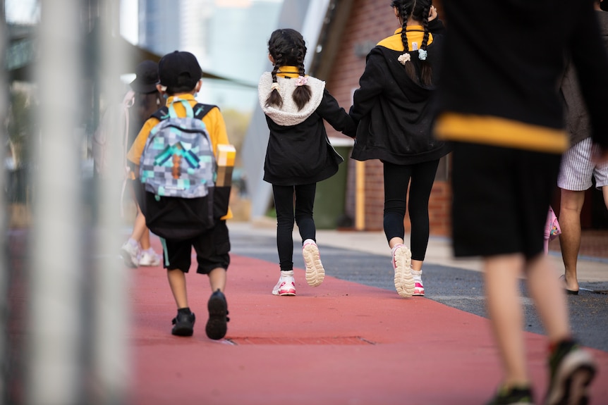 Lots of small children walking to class.