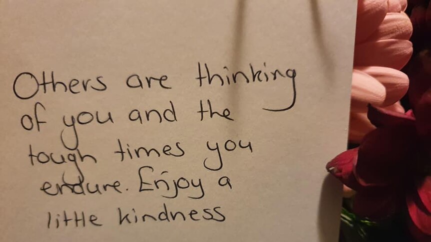 A note with words that read, others are thinking of you and the tough times you endure. Enjoy a little kindness.