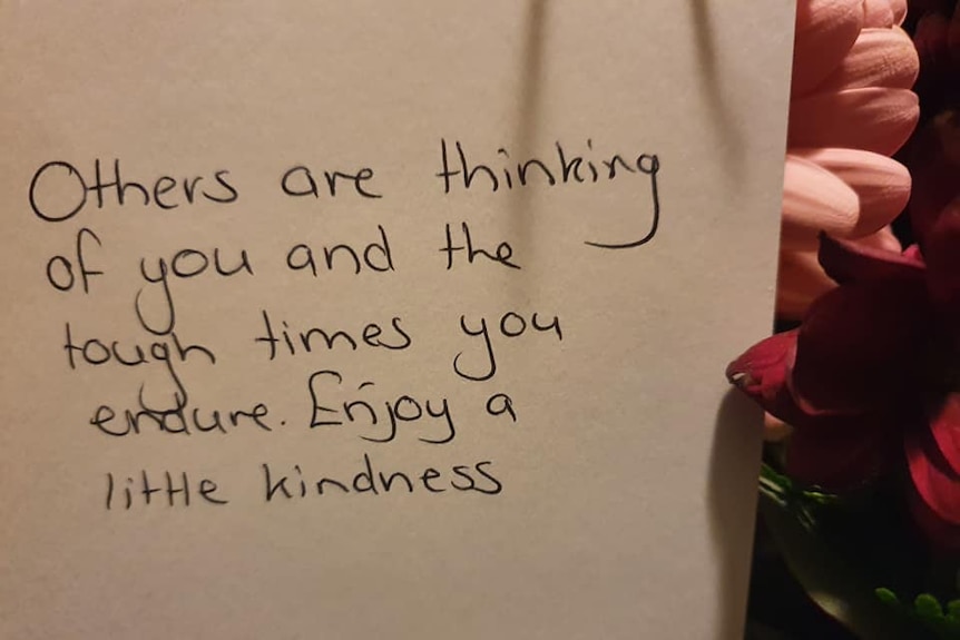 A note with words that read, others are thinking of you and the tough times you endure. Enjoy a little kindness.