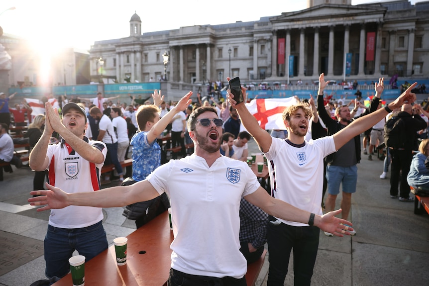 england soccer fans in england soccer jerseys stand and sing outside