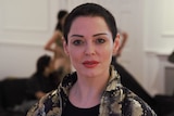 Rose McGowan in golden jacket.