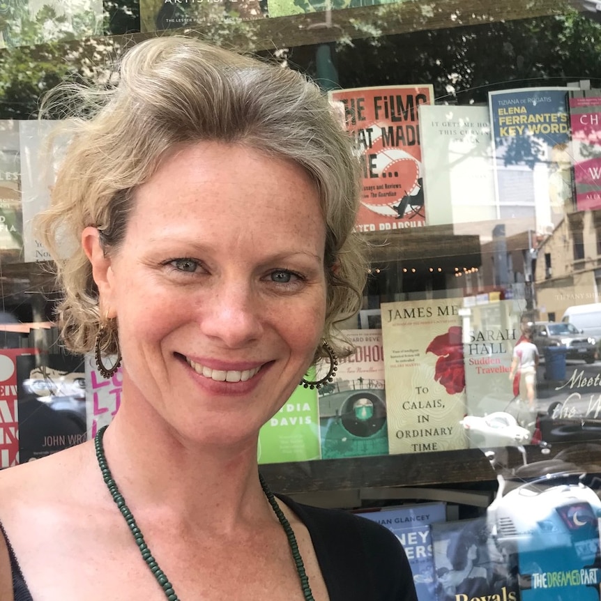 Tiffany Shellam standing in front of book shop window