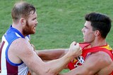 Brisbane's Daniel Merrett and Gold Coast's Jaeger O'Meara clash during the round three AFL match.