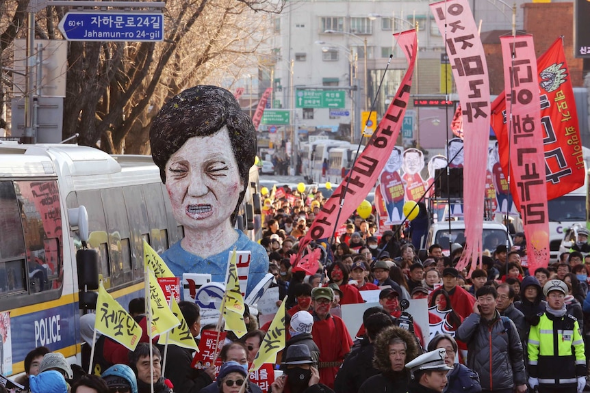 Protesters carry an effigy of impeached South Korean President Park Geun-hye.