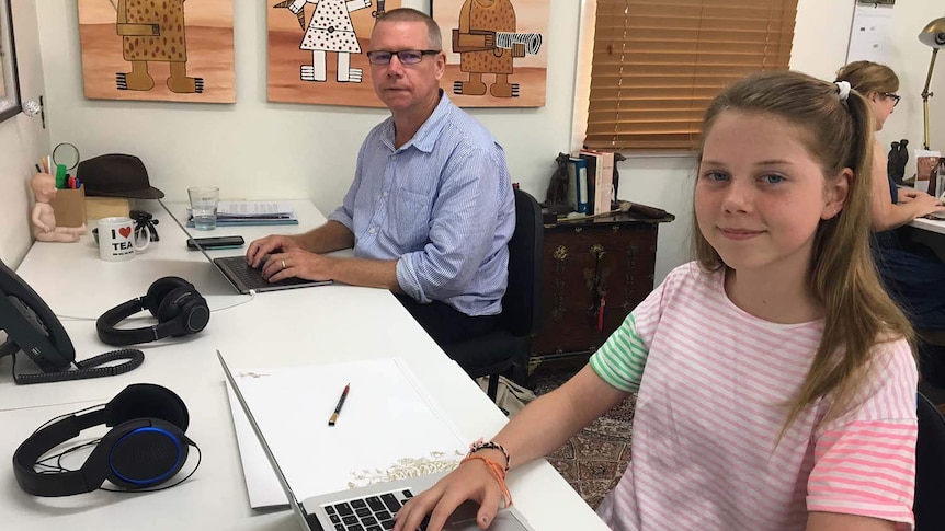 Jeff Smith with his 12-year-old daughter Arkie sitting at computers in their house in Brisbane in January 2018.
