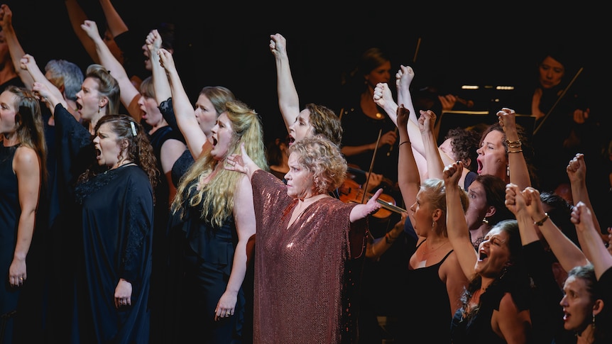 A display of strong women fist punching the air: Cassandra with the Women of Troy in Berlioz's opera, The Trojans.
