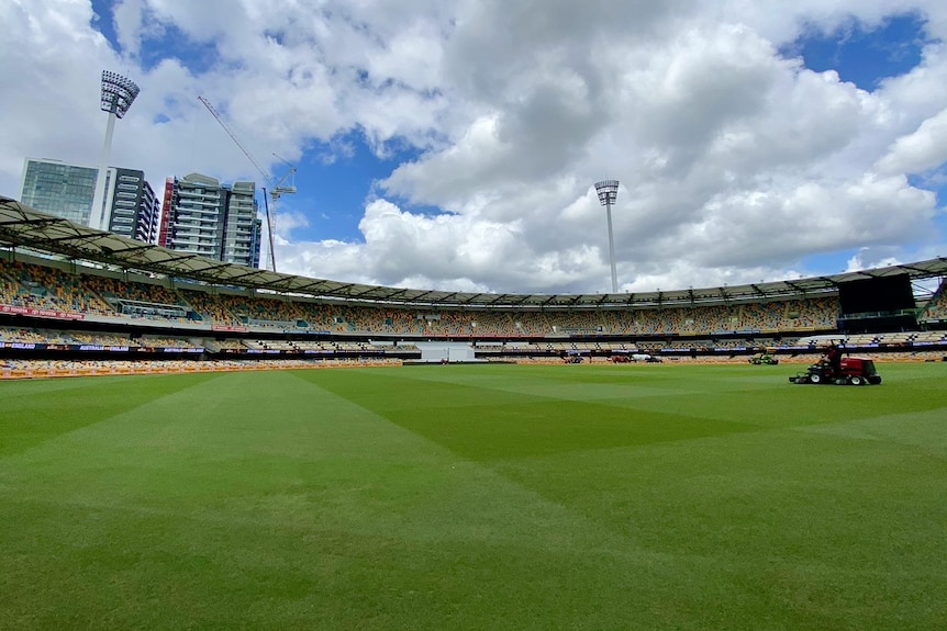 A view across the Gabba with light towers visible and a buildup of clouds overhead.