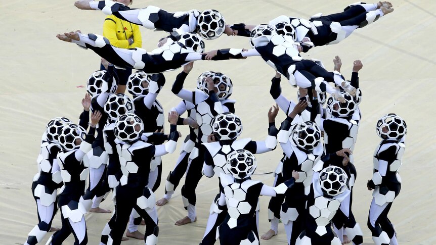 Performers take part in the 2014 World Cup opening ceremony at Arena de Sao Paulo.