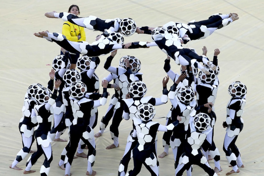 Performers take part in the 2014 World Cup opening ceremony at Arena de Sao Paulo.