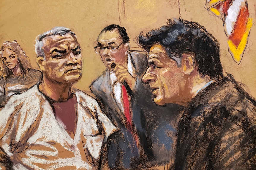 A courtroom sketch of a man in a prison uniform sitting as two men in suits lean towards him. 