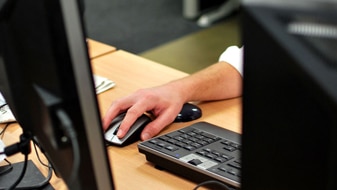 File image: Hand on computer mouse (ABC)