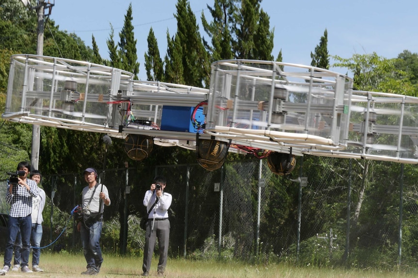 Journalists film Cartivator's flying car during its demonstration in Toyota, Japan, June 3, 2017.