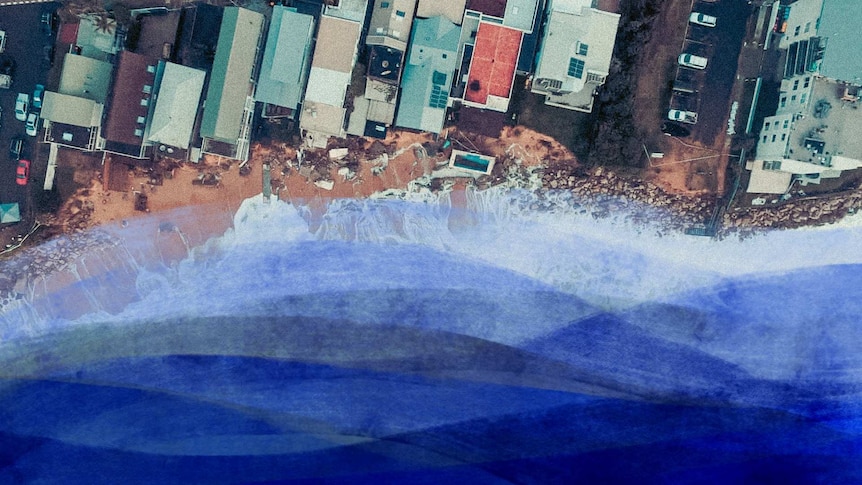 Drone view of houses right next to the coast damaged by the sea.