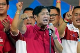 Ferdinand Marcos Jr gestures at the crowd during a political rally.