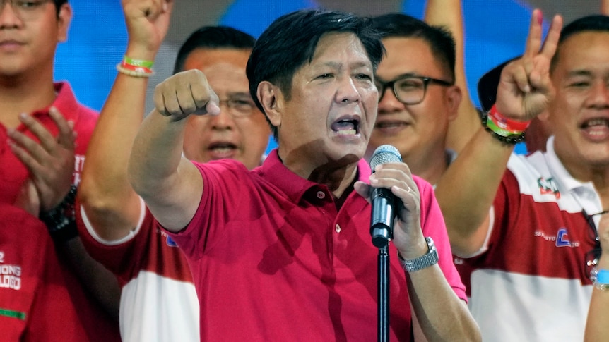 Ferdinand Marcos Jr gestures at the crowd during a political rally.