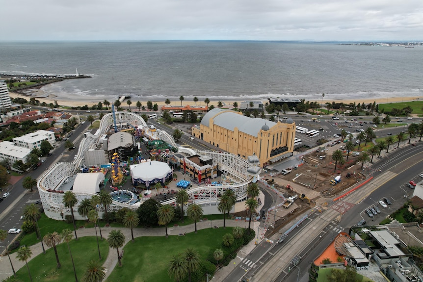 A drone shot of Luna Park and the Palais Theatre looking out over St Kilda beach. 