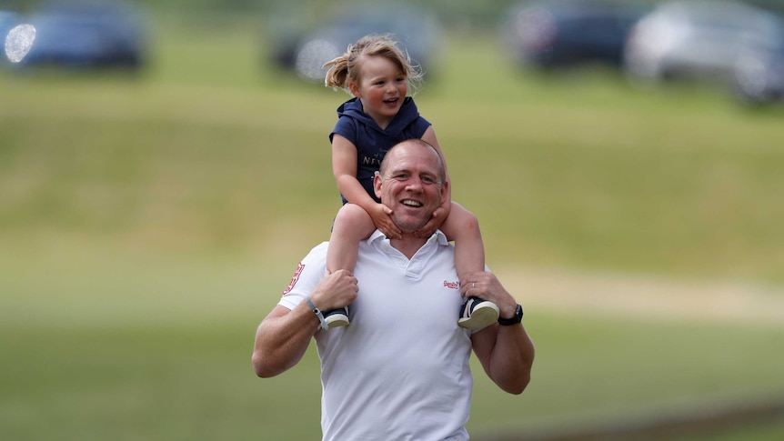 Mike Tindall carries his daughter Mia Tindall on his shoulders in 2017.