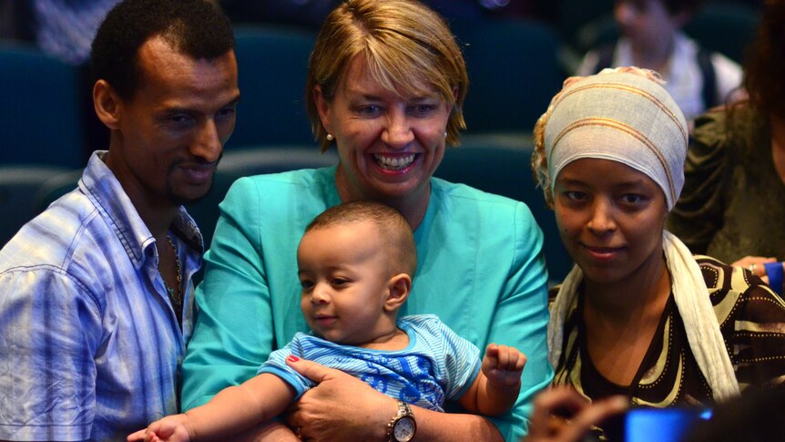 Queensland Premier Anna Bligh with new Australians Abiot and Fetiya and their 5-month-old son Eyob.