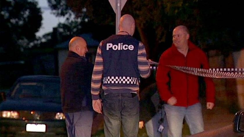 Police stand outside a house in Melbourne after 19 search warrants were executed this week.