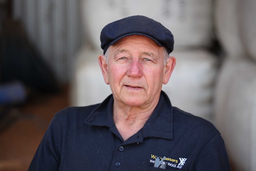 A portrait of an older man wearing a cap, serious expression