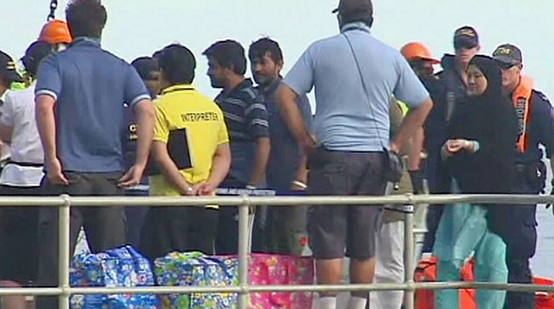 Asylum seekers bound for Malaysia arrive on Christmas Island on August 4, 2011.