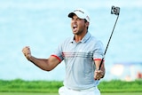 Jason Day of Australia reacts after sinking a putt