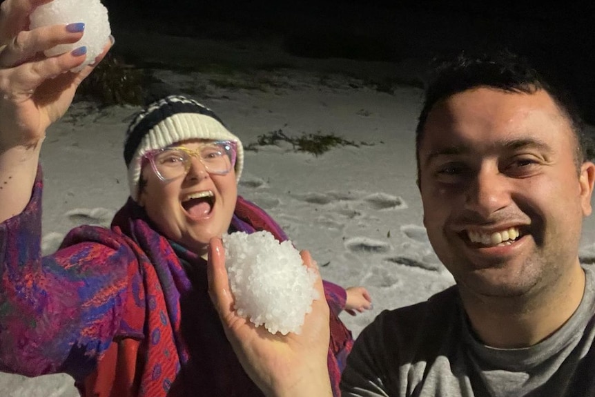 Adelaide Hills residents hold up balls of hail.