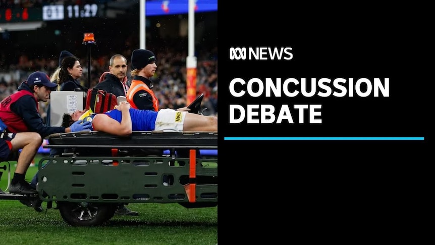 Concussion Debate: Prostrate AFL player lies on medical cart attended by doctors
