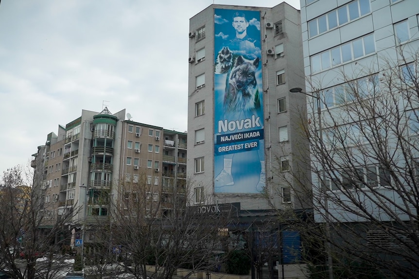 A huge poster of Novak Djokovic stands proudly over a busy Belgrade street.