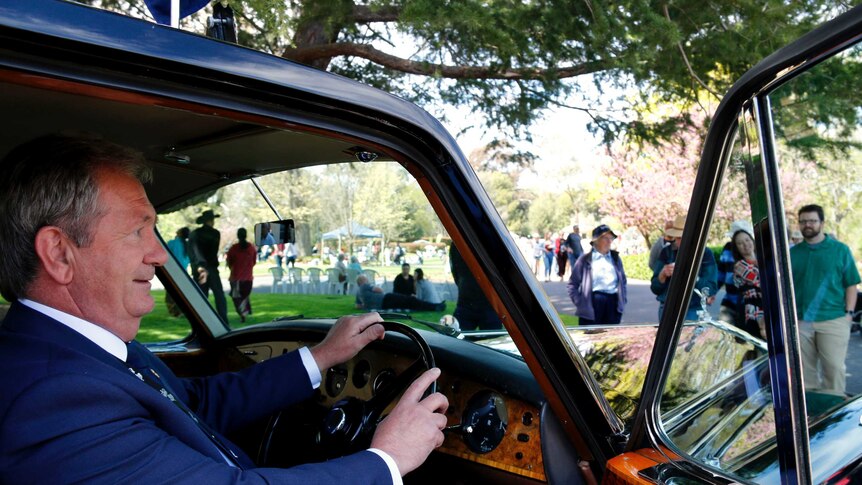 Official driver of the Governor General's ceremonial car, William Kelly inside the Rolls-Royce.