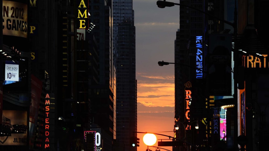 The sun sets as seen from 42nd street in New York City