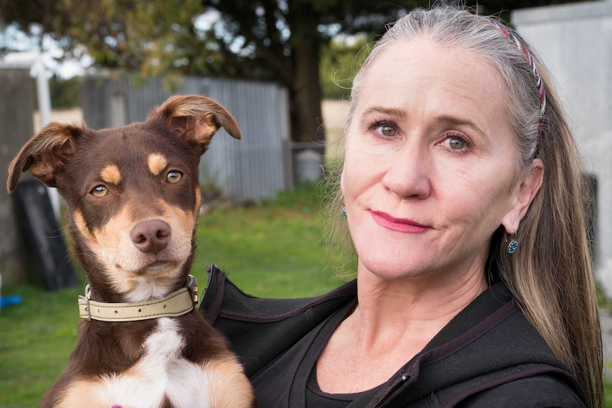 Di Edwards holds her rescue puppy Kelpie cross Harry in her arms