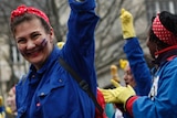 A woman laughs during a march as part of the International Women's Day, in Paris.