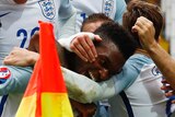 England mobs Daniel Sturridge after winner against Wales